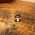 “Pride lives here” enamel pin by Sam Prentice-Jones