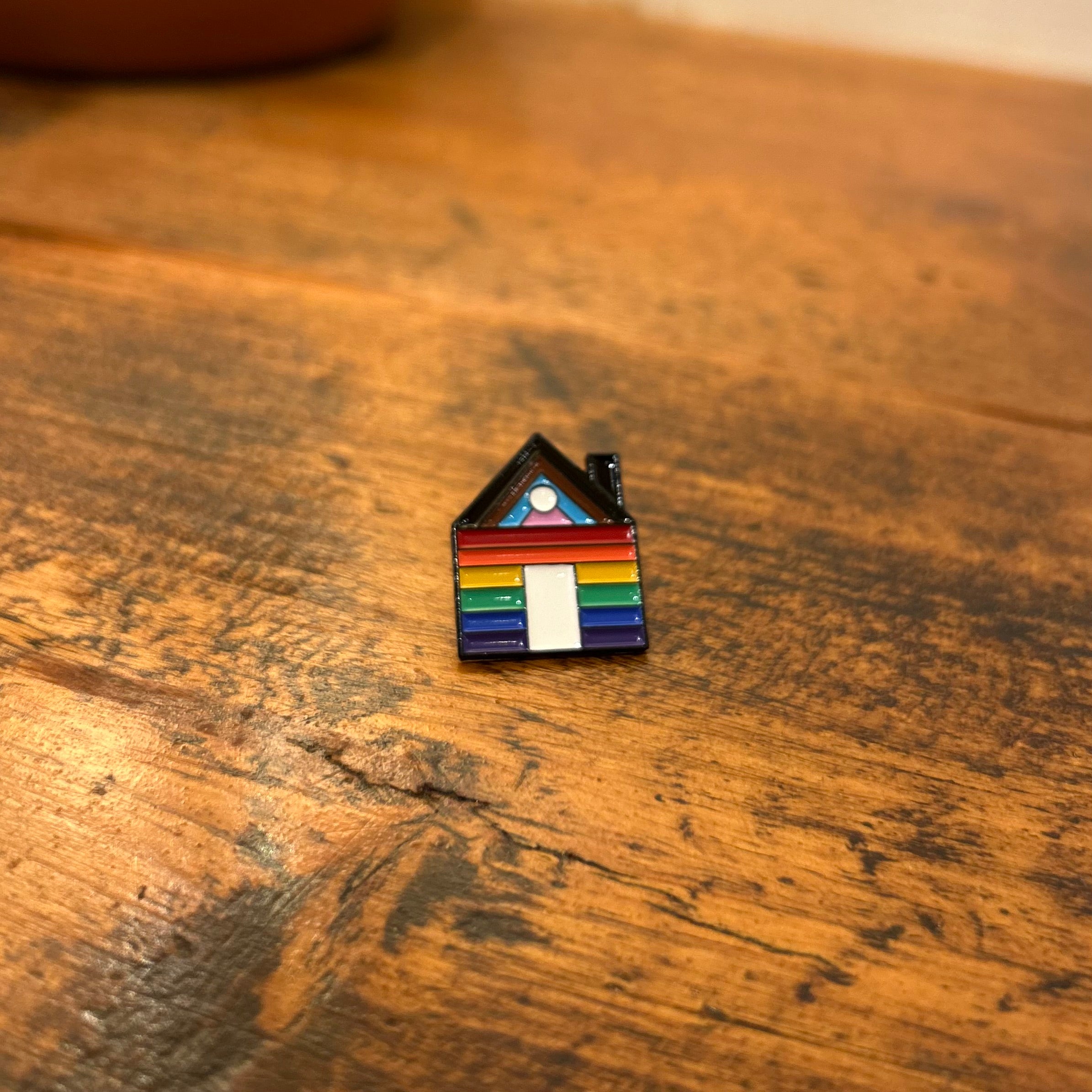 “Pride lives here” enamel pin by Sam Prentice-Jones